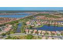 Scenic aerial view of a well-planned community with lakes, lush landscaping and tile roofs at 1021 Ancora Blvd, North Venice, FL 34275