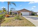 Well maintained house with a beautiful lawn and two car garage at 125 Golf Club Ln, Venice, FL 34293