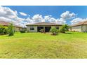 Spacious backyard with manicured lawn, offering ample space for outdoor activities and relaxation at 19889 Benissimo Dr, Venice, FL 34293