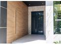 Elegant entryway featuring wood-paneled walls, marble accents, and a modern black double door at 2375 Floyd St, Sarasota, FL 34239