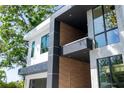 Contemporary home design with a balcony, showcasing a blend of wood, marble, and sleek black accents at 2375 Floyd St, Sarasota, FL 34239