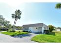 Well-maintained home featuring a clean white exterior and lush green lawn at 2752 Riverbluff Pl # 66, Sarasota, FL 34231