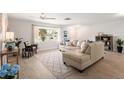 Bright living room with wood-look floors, a large window, and neutral furniture at 2933 Mayflower St, Sarasota, FL 34231