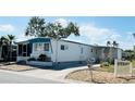 Well-kept mobile home with a cozy porch, a neatly landscaped yard, and a convenient driveway at 3414 Spanish Oak Ter, Sarasota, FL 34237