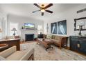 Bright living room boasts a fireplace, hardwood floors, and an elegant ceiling fan at 4109 Riverview Blvd, Bradenton, FL 34209