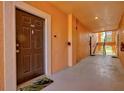 Hallway to residences with a dark wooden door and stairs in the background at 4178 Central Sarasota Pkwy # 325, Sarasota, FL 34238