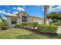 Lovely single-story home showcasing beautiful landscaping, a manicured lawn, and an American flag at 4181 Brittany Ln # 25, Sarasota, FL 34233