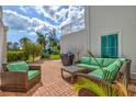 Cozy backyard patio with comfortable outdoor furniture, grill, and well-maintained landscaping at 5055 Gulf Of Mexico Dr # 115, Longboat Key, FL 34228