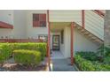 Charming condo entrance featuring unit 515 with well-maintained landscaping and an outdoor staircase at 515 Spring Lakes Blvd # 515, Bradenton, FL 34210