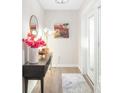 Bright foyer with modern decor, a stylish mirror, and decorative accents creating a welcoming entrance at 5247 Carmilfra Dr, Sarasota, FL 34231