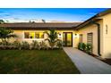 Inviting single-story home with a well-maintained lawn, a freshly paved walkway, and tasteful landscaping at 5247 Carmilfra Dr, Sarasota, FL 34231
