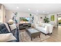 Comfortable living room with contemporary furnishings, stylish artwork, and an abundance of natural light at 5247 Carmilfra Dr, Sarasota, FL 34231