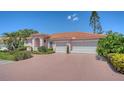 Lovely single-story home featuring a three-car garage and a brick paver driveway at 5270 Far Oak Cir, Sarasota, FL 34238