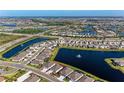 Aerial view of a residential community with houses around ponds and lush landscaping at 5336 Grove Mill Loop, Lakewood Ranch, FL 34211