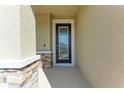 Close-up of a front door featuring decorative stone accents and a glass insert at 5336 Grove Mill Loop, Lakewood Ranch, FL 34211