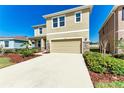 Charming two-story home with neutral stucco and a well-manicured lawn and driveway at 5336 Grove Mill Loop, Lakewood Ranch, FL 34211
