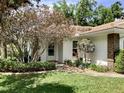 Inviting front entrance with lush landscaping and a pathway leading to the door at 5714 Garden Lakes Dr, Bradenton, FL 34203