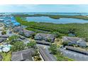 Aerial view of condos with waterfront and lake views and assigned carport parking at 628 Estuary Dr, Bradenton, FL 34209