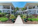 Well-maintained condo building with symmetrical design, lush landscaping and convenient walkways at 628 Estuary Dr, Bradenton, FL 34209
