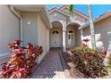 Inviting front entrance showcasing a brick pathway and beautiful landscaping at 6324 41St E Ct, Sarasota, FL 34243