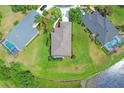 An aerial view of a home showcasing its location, surrounding greenery, and proximity to a water feature at 7710 Seven Oaks Dr, Bradenton, FL 34201