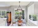 A charming breakfast nook featuring a glass-top table, neutral tones and sliding glass doors at 7710 Seven Oaks Dr, Bradenton, FL 34201