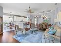 An open-concept living room boasts hardwood floors, neutral tones, and seamless flow into the dining area at 7710 Seven Oaks Dr, Bradenton, FL 34201