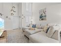 Inviting living room space with large sectional, coastal decor and plenty of natural light at 800 S Blvd Of The Presidents # 3, Sarasota, FL 34236