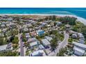 Aerial view showcasing the home's proximity to the beach and its location within a charming residential neighborhood at 805 N Bay Blvd, Anna Maria, FL 34216