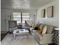 Inviting living room with neutral tones, comfortable seating, and natural light from the window at 831 Bacon Ave, Sarasota, FL 34232