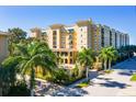 Lovely exterior view of the building with palm trees and a pristine blue sky at 1064 N Tamiami Trl # 1604, Sarasota, FL 34236