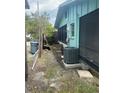 Exterior side view of house, showcasing the yard with AC unit at 109 Colonia W Ln, Nokomis, FL 34275