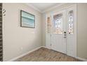 Inviting entryway featuring decorative glass door, tile flooring, and elegant trim at 11499 Renaissance Blvd, Venice, FL 34293