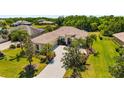 Beautiful home boasts lush landscaping, a tile roof, and a spacious driveway at 12810 Kite Dr, Bradenton, FL 34212