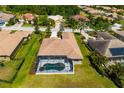 Aerial shot of a private screened pool and spa with lush green surroundings at 12810 Kite Dr, Bradenton, FL 34212