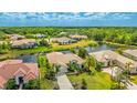 Neighborhood view showing homes with tropical landscaping and a serene waterway behind this house at 12822 Kite Dr, Bradenton, FL 34212