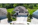 Beautifully landscaped home with mature trees, a three-car garage and a lush green lawn at 12841 Balsam Ter, Bradenton, FL 34212