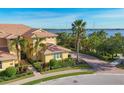 Inviting two-story home with brick driveway and manicured landscaping, showcasing tropical curb appeal at 1294 Riverscape St # D, Bradenton, FL 34208