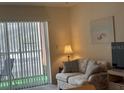 Bright living room with large window, artwork, and comfortable seating at 1330 Glen Oaks E Dr # 276D, Sarasota, FL 34232