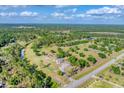Breathtaking aerial view of the property's expansive lot and surrounding lush green landscape at 1668 Tropicaire Blvd, North Port, FL 34286