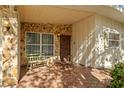 Charming front porch with stone accents, decorative wood door, and inviting tiled flooring at 2110 Euclid Ter, Sarasota, FL 34239