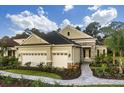 Beautiful home with a stone facade, lush landscaping, and a two-car garage, showcasing curb appeal at 21221 Wacissa Dr, Venice, FL 34293
