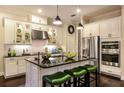 Stylish kitchen featuring stainless steel appliances, a center island with seating, and ample cabinet space at 21221 Wacissa Dr, Venice, FL 34293