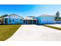 Inviting home with a spacious driveway, screened porch, and a two-car garage at 2703 Avenue B, Holmes Beach, FL 34217
