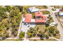 Aerial view of the home highlighting the roof, outdoor area, and lush landscaping, along with the sparkling swimming pool nearby at 280 W Cowles St, Englewood, FL 34223