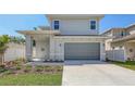 Charming two-story home with grey siding, a two-car garage, and a well-manicured lawn at 2926 River Run Way, Bradenton, FL 34208