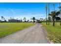 Long gravel driveway leading to the home and outbuildings, offering privacy and space at 29527 Maris Dr, Punta Gorda, FL 33982