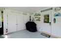 Covered carport area featuring ample storage, beach-themed decor, and a convenient access door to the home at 3112 Cambridge Ave # 6, Bradenton, FL 34207