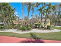 Bright yellow home boasts lush landscaping, showcasing a well-maintained front yard at 322 S Washington Dr, Sarasota, FL 34236