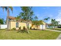 A charming single-Gathering home showcasing the front yard, appealing landscaping and lovely architecture at 3413 5Th W Dr, Palmetto, FL 34221